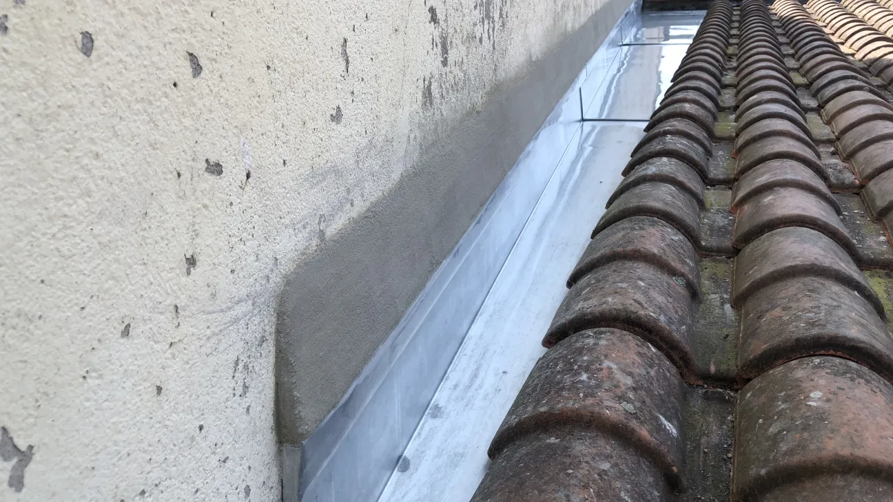 Chéneaux de rive en zinc avec bande porte solin et mortier